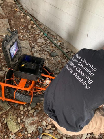 Technician performing drain camera inspection to identify underground pipe issues
