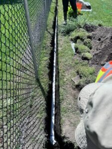 Drain tile installation in a residential yard using PVC pipe in Vancouver, BC.