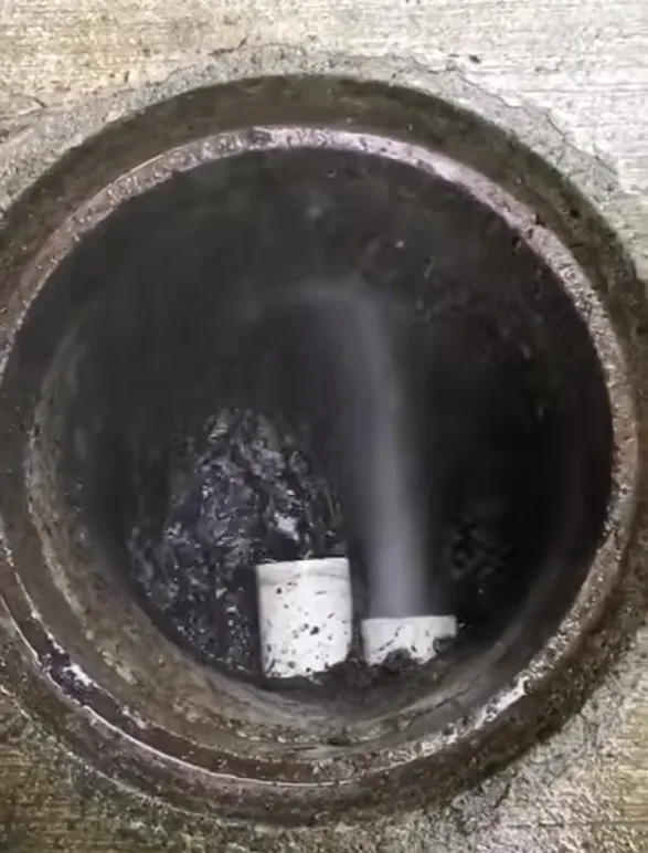 Hydro flushing sediment from underground drainage
