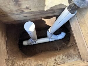 PVC pipe installed to connect a catch basin and cleanout pipe for residential drainage in Vancouver, BC.