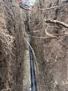 Drain tile installed in a trench for a residential perimeter drainage system in Vancouver, BC.