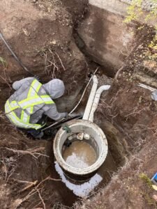 Drain tile connected to a residential sump pit during perimeter drainage installation in Vancouver, BC.