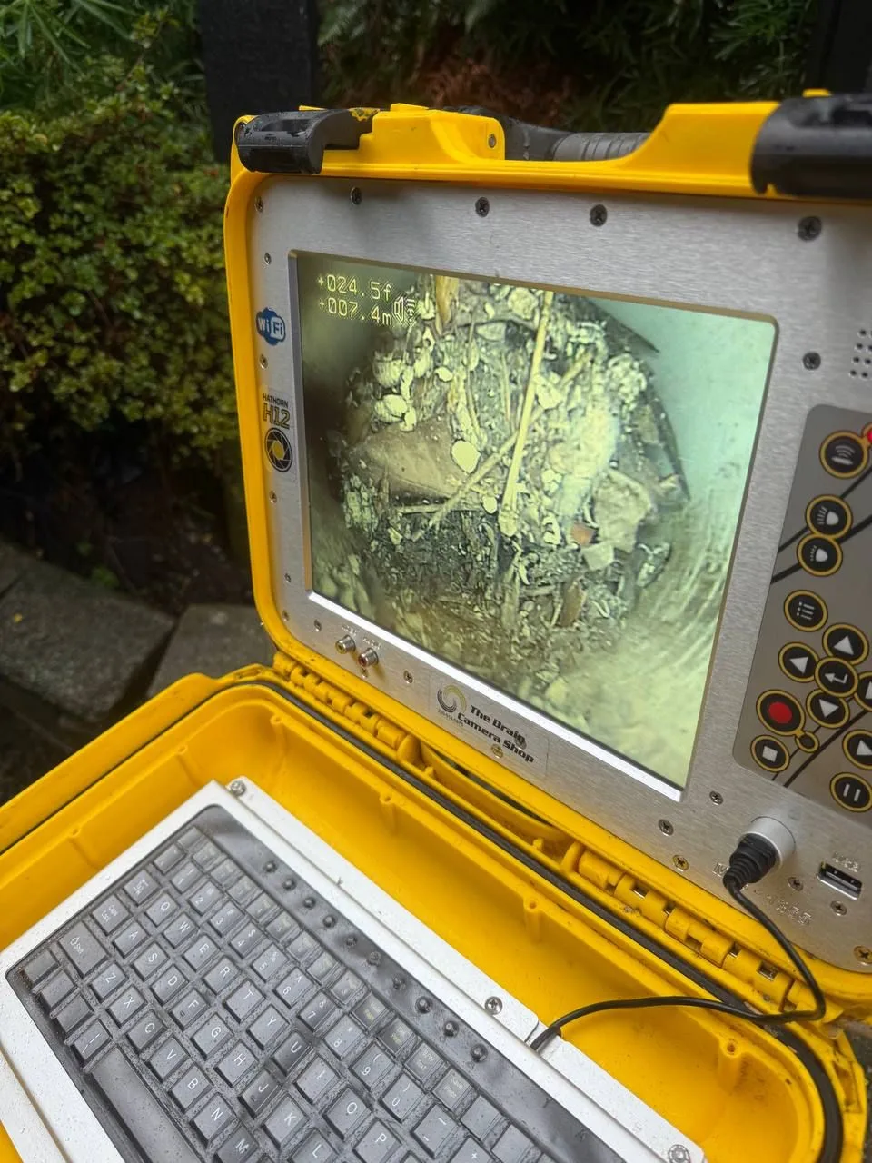 Drain inspection camera displaying the inside of an underground clay drainage pipe