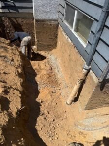 Trench excavated beside a Vancouver home before French drain installation