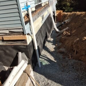 Foundation waterproofing and drainage gravel installed beside a Vancouver home