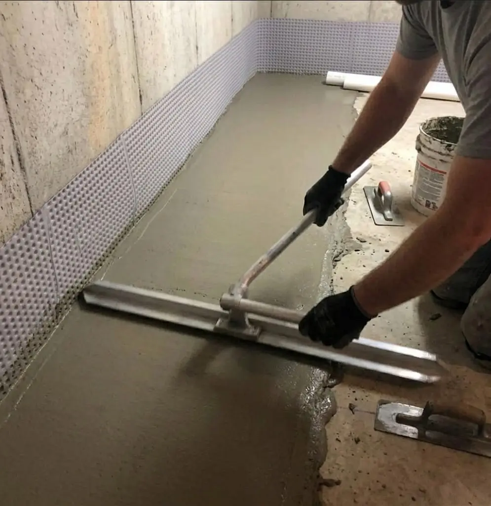 Restoring the concrete floor after basement drain installation
