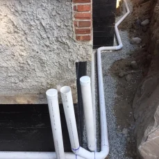 Underground perimeter drain repair to resolve damaged drainage pipes